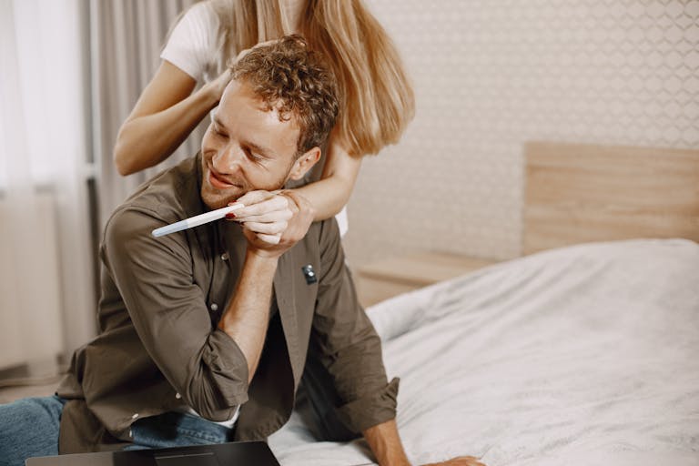 Couple celebrating positive pregnancy test — Male Fertility